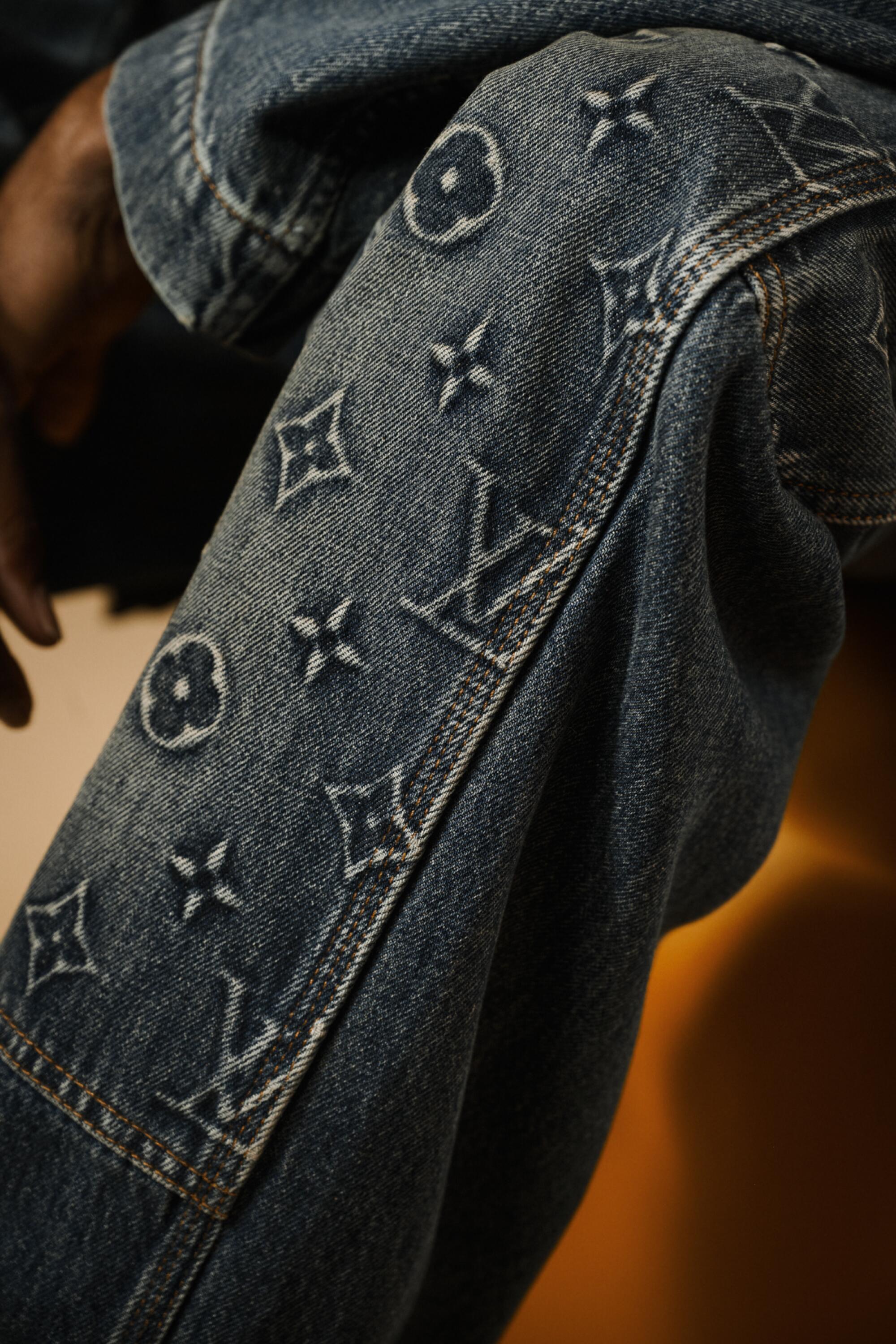 A detail of patterned Louis Vuitton jeans.