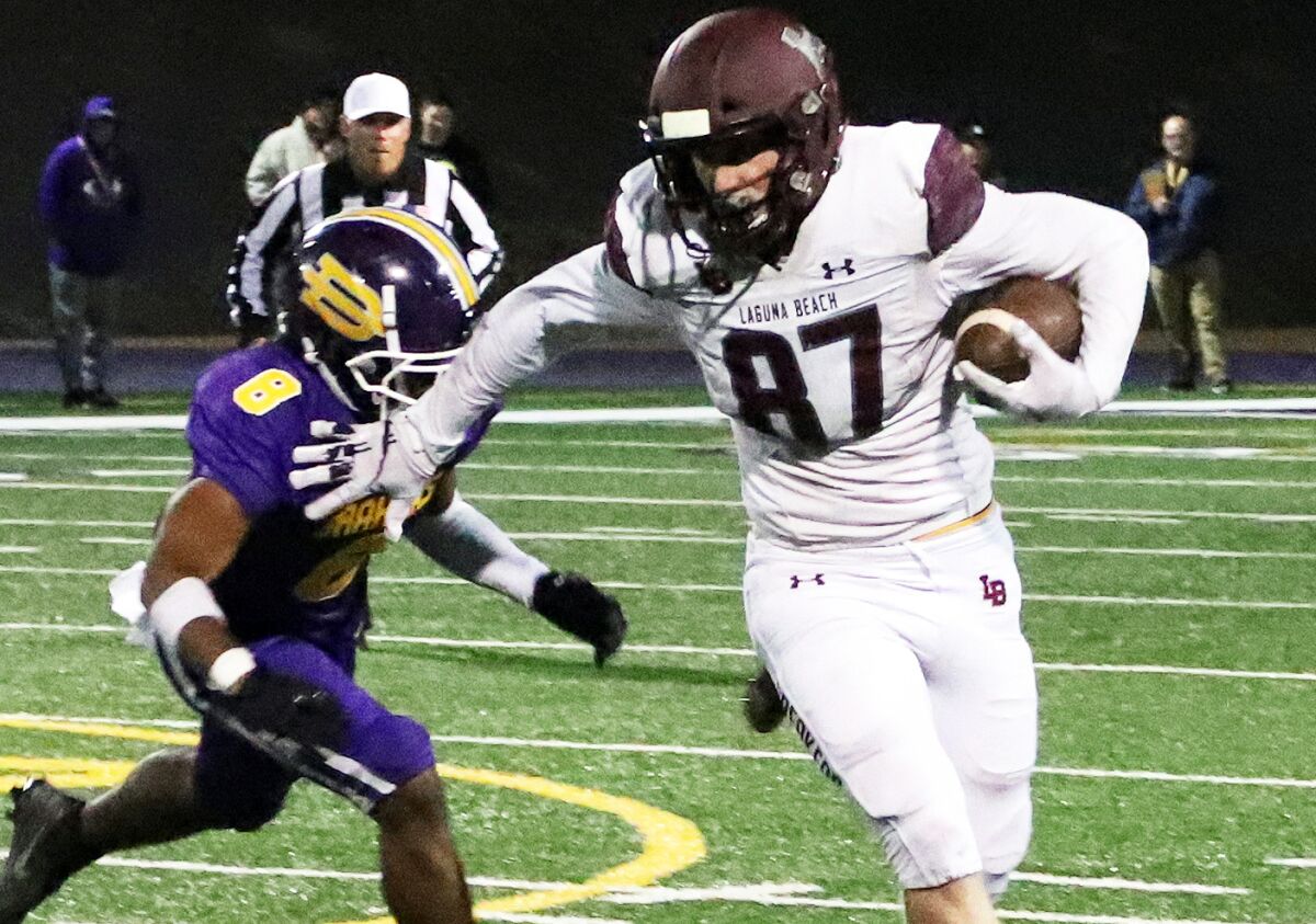 Laguna Beach's Ryner Swanson (87) runs past Diamond Bar's Kai Jenkins (8) on Nov. 26, 2022.