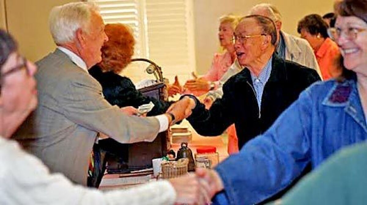 GREETING: Los Angeles Breakfast Club members and guests exchange their decades-old flipping the egg handshake.