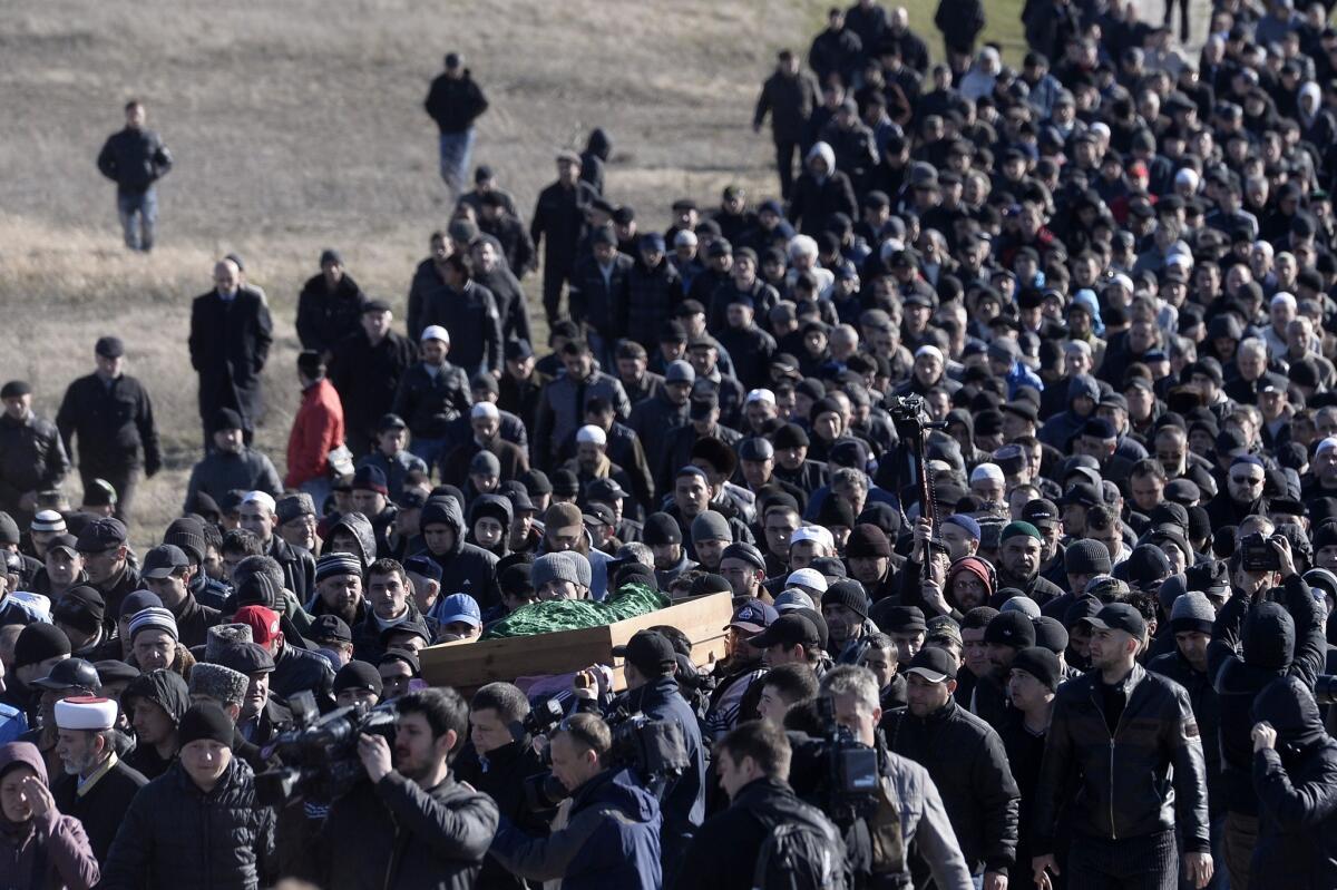 Members of the Crimean Tatar community carry the coffin of Reshat Ametov during his funeral in Simferopol. Ametov, who had been protesting against Russian troops in the Crimean peninsula, was reportedly found dead days after he was seen being hauled away by men in military-style jackets.