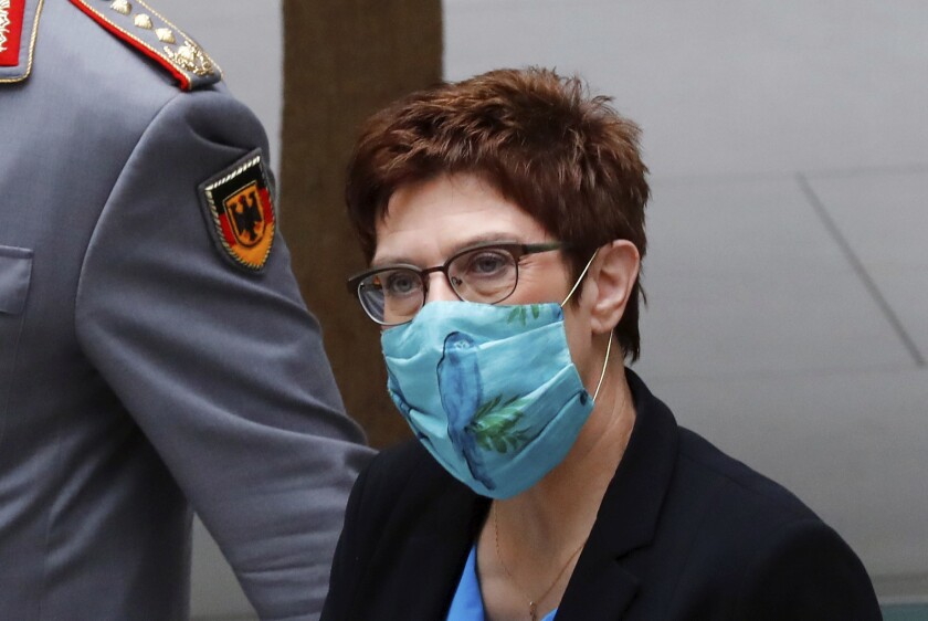 Defense Minister Annegret Kramp-Karrenbauer (CDU) arrives at a press conference on the reform of the Special Forces Command (KSK), wearing mouth and nose protection, Berlin Germany, Wednesday, July 1, 2020. Since 2017, the KSK has been making headlines because of several cases of right-wing extremism. One suspected soldier even had an arsenal dug up. The Defence Minister has therefore had a reform concept developed to counteract extremist tendencies. (Kay Nietfeld/dpa via AP)