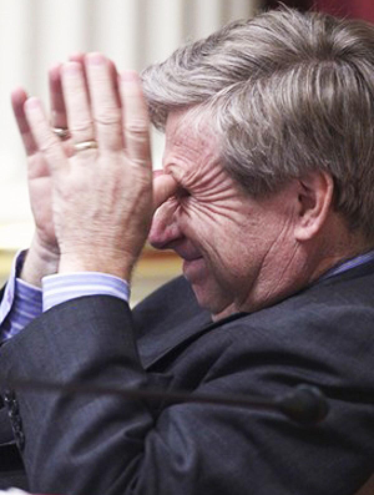 State Sen. George Runner, a Republican from Lancaster, rubs his eyes during the budget debate.
