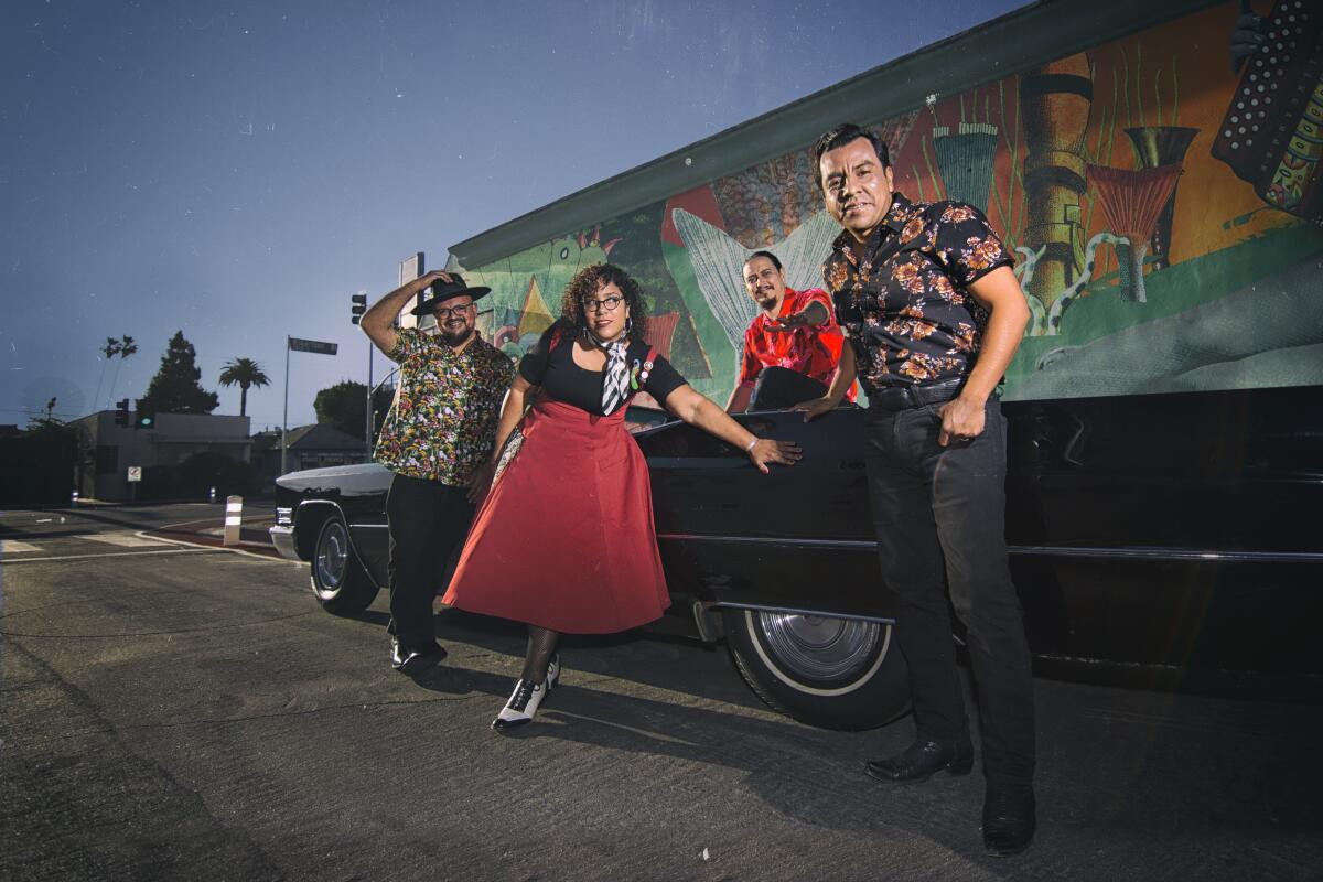 Marisol "La Marisoul" Hernandez is shown with the other members of La Santa Cecilia.