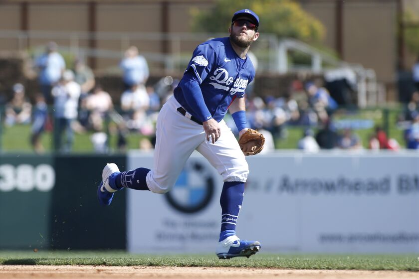 GLENDALE, ARIZONA - FEBRUARY 24: Second baseman Max Muncy #13 of the Los Angeles Dodgers chases down a fly ball during a Cactus League spring training game against the Chicago White Sox at Camelback Ranch on February 24, 2020 in Glendale, Arizona. (Photo by Ralph Freso/Getty Images)