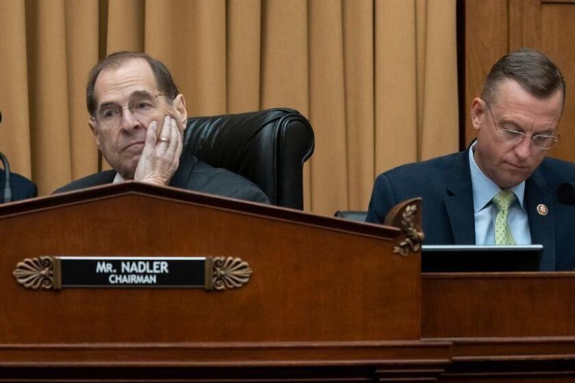 House Judiciary Committee Chair Jerrold Nadler, D-N.Y., joined at right by Rep. Doug Collins, R-Georgia, the ranking member, waits to start a hearing on the Mueller report without witness Attorney General William Barr who refused to appear, escalating an already acrimonious battle between Democrats and the Justice Department, on Capitol Hill in Washington, Thursday, May 2, 2019. (AP Photo/J. Scott Applewhite)