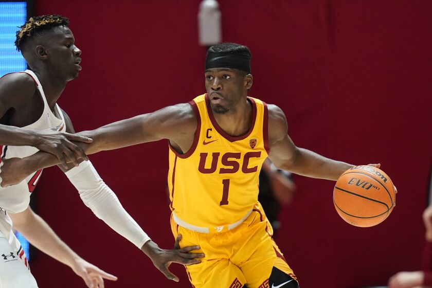 USC's Chevez Goodwin tries to get past Utah's Lahat Thioune on Jan. 22 in Salt Lake City.