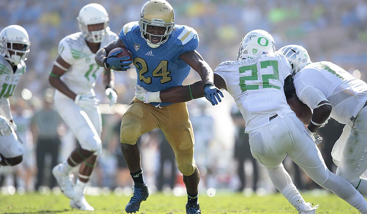 UCLA running back Paul Perkins (24) gets past Oregon defensive back Derrick Malone Jr. on a 15-yard run to the five-yard line in the second half.