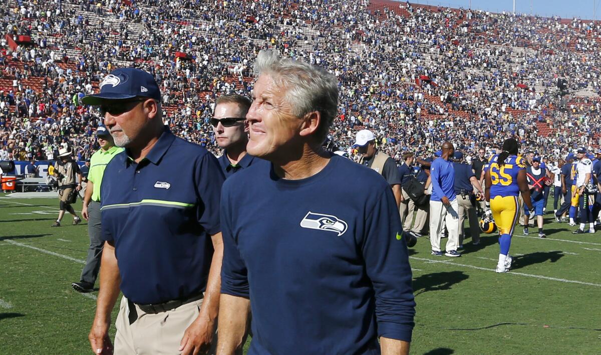 Seahawks Coach Pete Carroll walks off the field after a 9-3 loss to the Rams on Sunday.