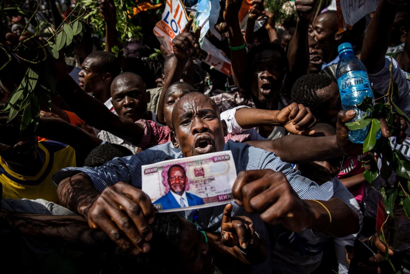 Supporters react before Kenyan opposition leader Raila Odinga has himself "sworn in" as the "people's president" in Nairobi.