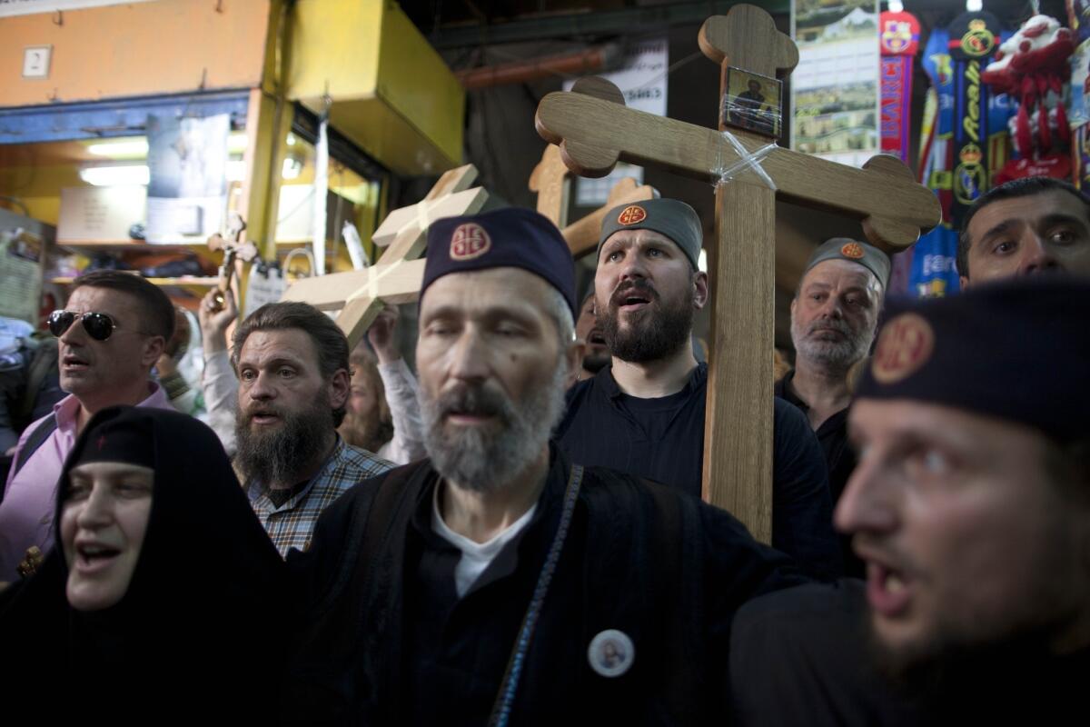 Orthodox Christian pilgrims hold wooden crosses as they take part in the Good Friday procession along the Via Dolorosa in Jerusalem's Old City on Friday.