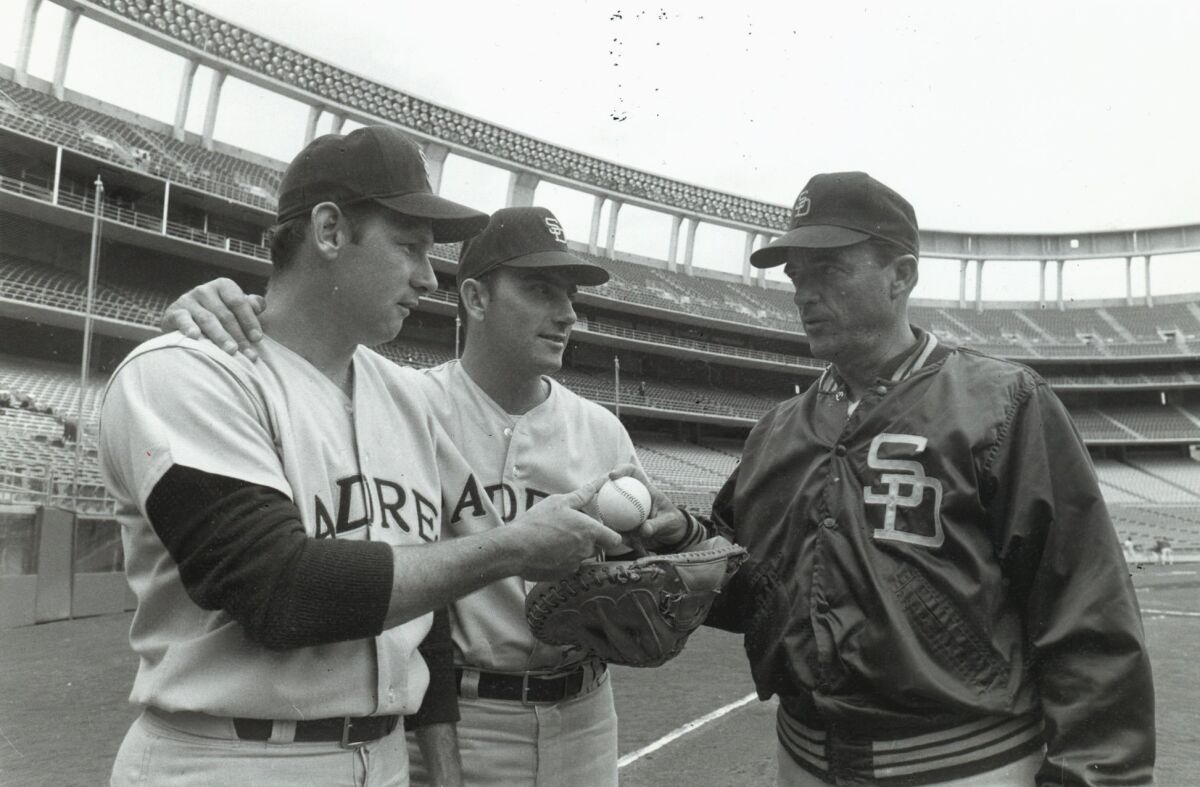 Opening Day Padres pitcher Dick Selma (left) and catcher Chris Cannizzaro talk with manager Preston Gomez at San Diego Stadium, where the major league Padres later played their first game.