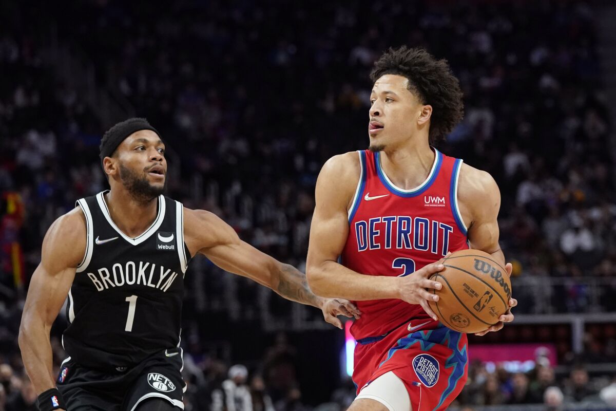 Detroit Pistons guard Cade Cunningham (2) is defended by Brooklyn Nets forward Bruce Brown (1) during the second half of an NBA basketball game, Friday, Nov. 5, 2021, in Detroit. (AP Photo/Carlos Osorio)