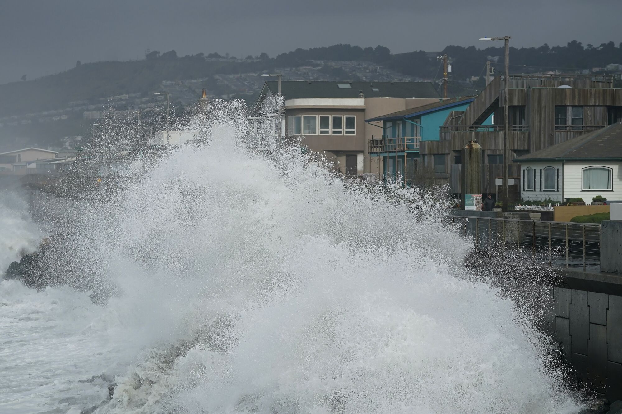 A huge wave crashes into the sea wall
