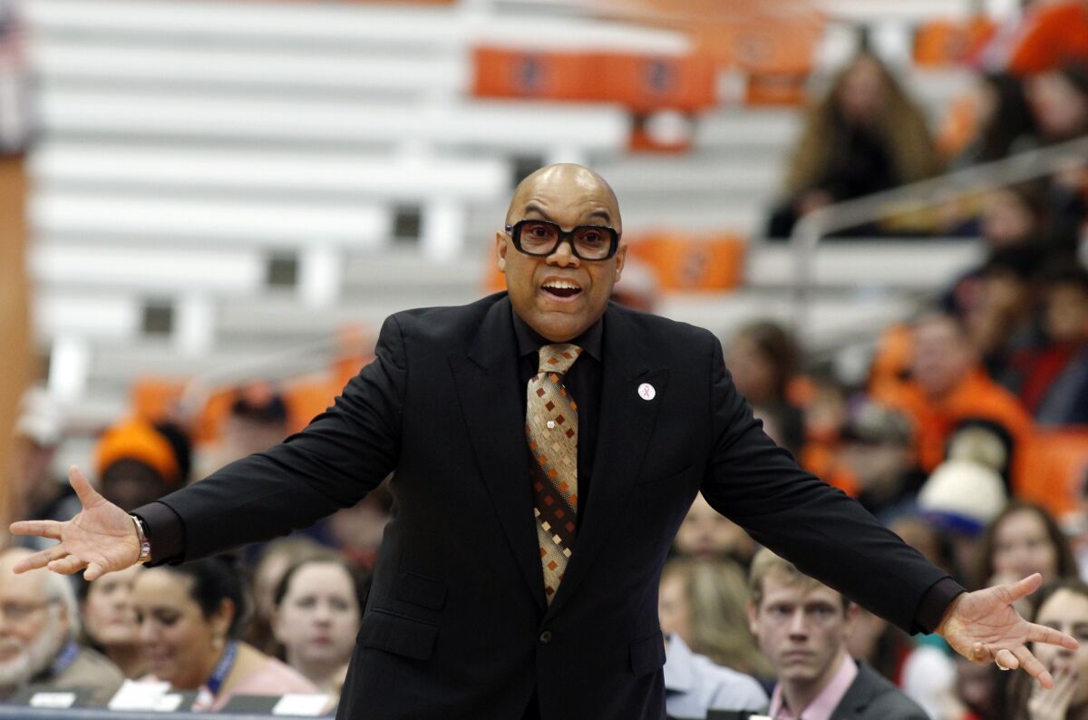 FILE - In this Feb. 9, 2020, file photo, Syracuse head coach Quentin Hillsman yells to his players in the first quarter of an NCAA college basketball game against Louisville in Syracuse, The Syracuse women’s basketball coach who resigned after players accused him of bullying has been hired by a professional club in Spain. Leganés in Madrid announced the signing of Quentin Hillsman a month after he stepped down amid an external review of his program. He left Syracuse after 15 seasons in charge when he was accused by former players and staff of threats, bullying and unwanted physical contact. (AP Photo/Nick Lisi, File)