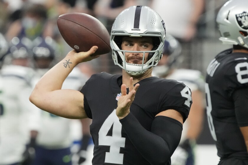 Las Vegas Raiders quarterback Derek Carr warms up before a preseason game against the Seattle Seahawks on Aug. 14.