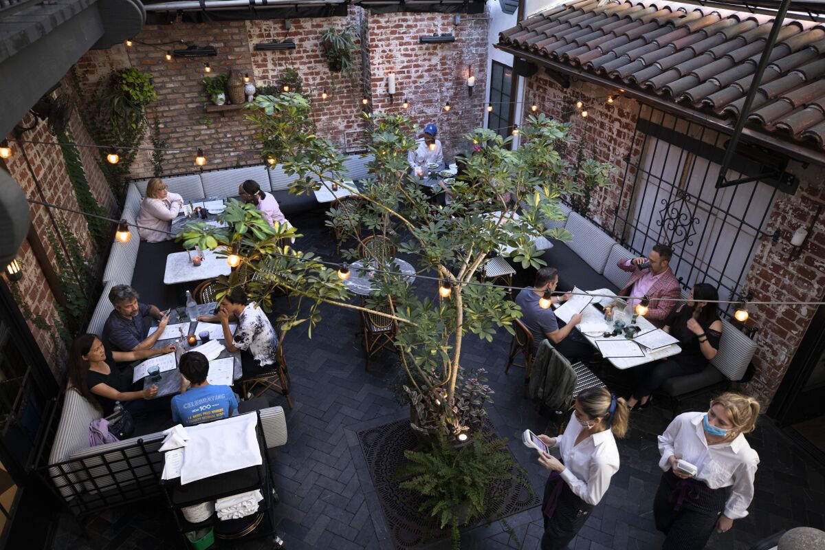 People eat in a restaurant courtyard.