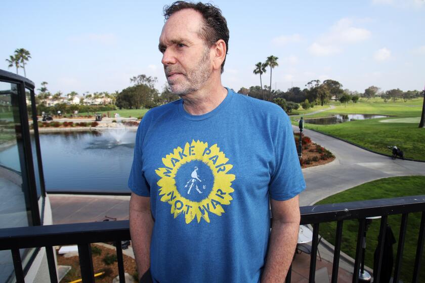 Jeff Fitzhugh the CEO of Linksoul and a Huntington Beach resident poses for a picture at the Huntington Beach Club in Huntington Beach on Friday, April 1, 2022. Fitzhugh created a T-shirt called "Make Par Not War" and organized a fundraiser to support the people of Ukraine, his team has already raised over $60,00. (Photo by James Carbone)