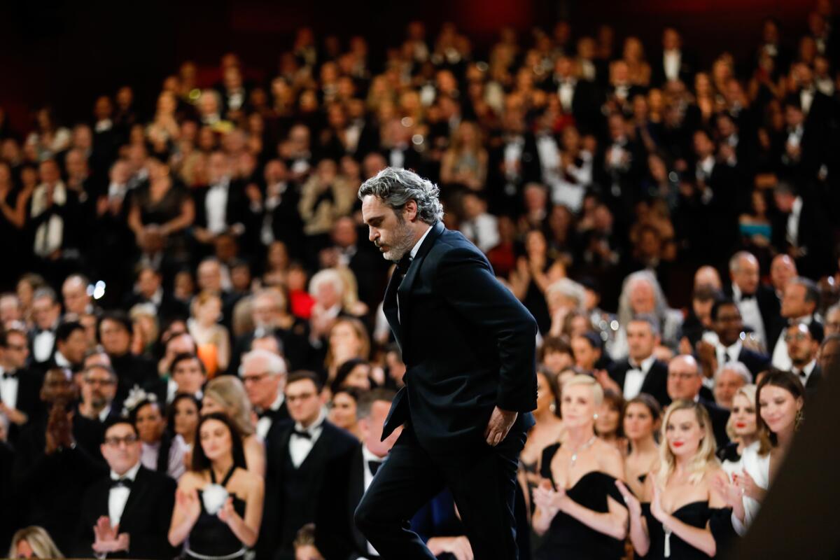 Joaquin Phoenix heads to the stage to accept his lead actor Oscar for "Joker"