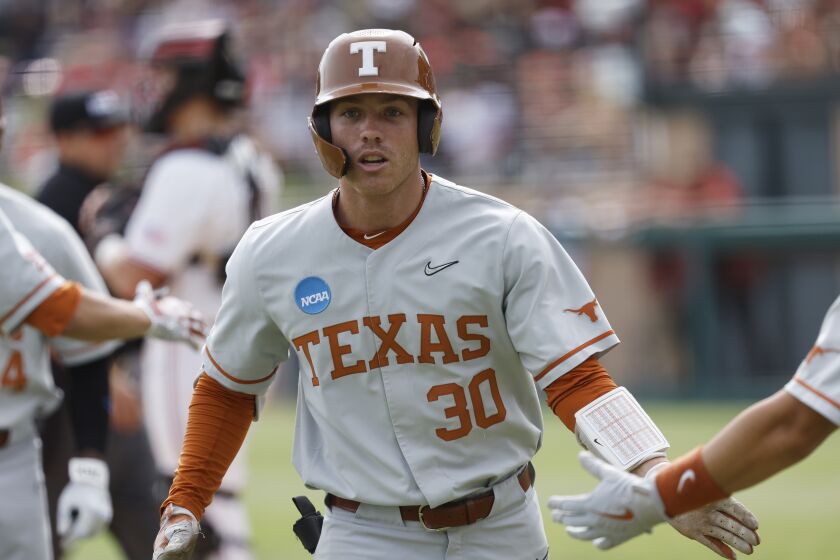 Texas outfielder Eric Kennedy celebrates after scoring on a two-run home run against Stanford in the fifth inning of an NCAA college baseball tournament super regional game in Stanford, Calif., Saturday, June 10, 2023. (AP Photo/Josie Lepe)