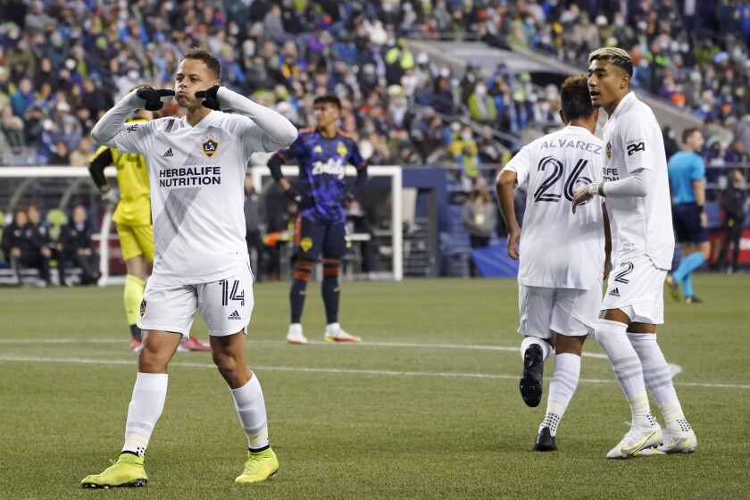 Galaxy forward Javier "Chicharito" Hernandez (14) celebrates in front of the Sounders supporters section