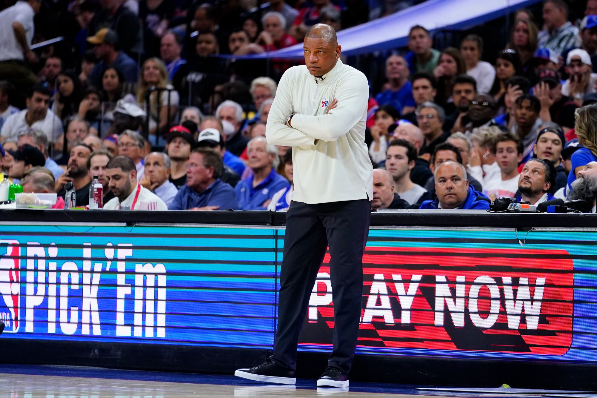 Philadelphia 76ers coach Doc Rivers has his arms folded as he watches Game 6 standing along the sideline.