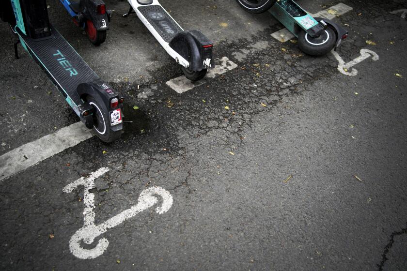Scooters are parked in Paris, Friday, march 31, 2023. Romantically zipping two-to-a-scooter, wind in the hair, past the Eiffel Tower and other iconic sights could soon become a thing of the past if Parisians vote Sunday to do away with the 15,000 opinion-dividing micro-machines. (AP Photo/Christophe Ena)
