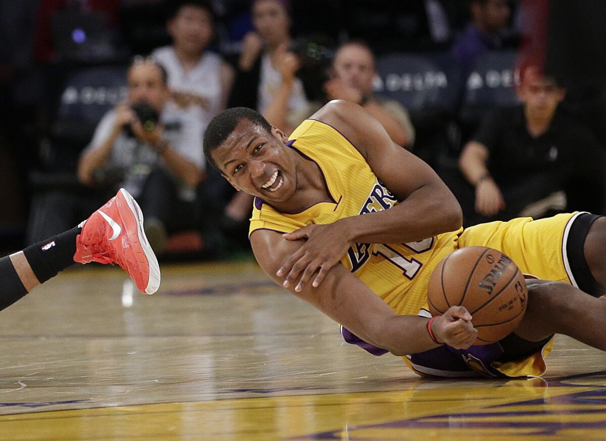 Lakers forward Jonathan Holmes grabs his shoulder after a collision with Portland's Allen Crabbe during the first half of a preseason game on Oct. 19.