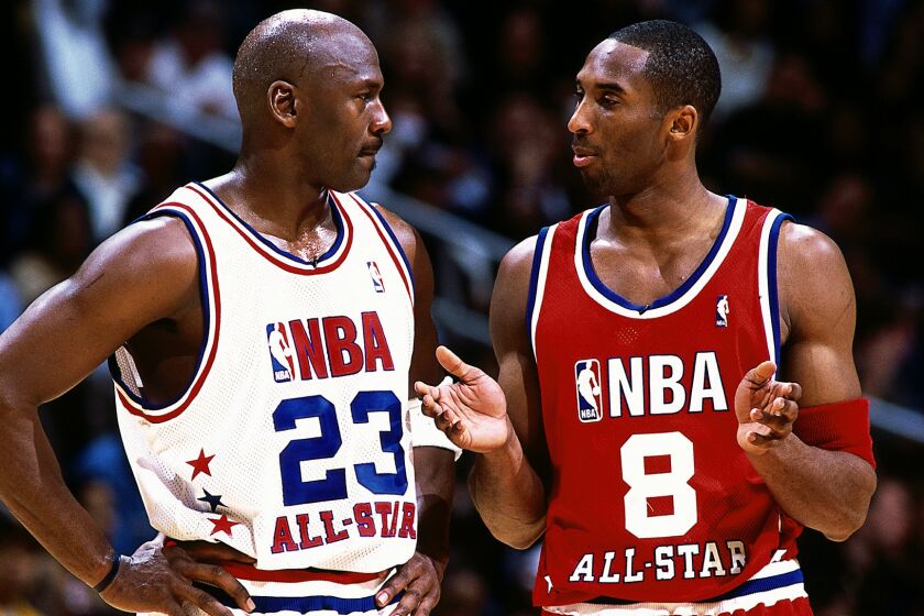 Kobe Bryant, right, speaks with Michael Jordan, then with the Washington Wizards, during the 2003 NBA All-Star Game in Atlanta.