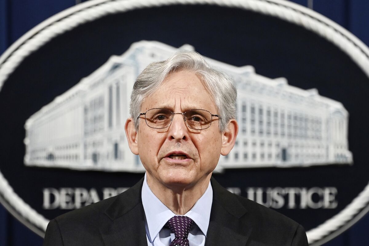 Head shot of Merrick Garland in front of the Department of Justice seal