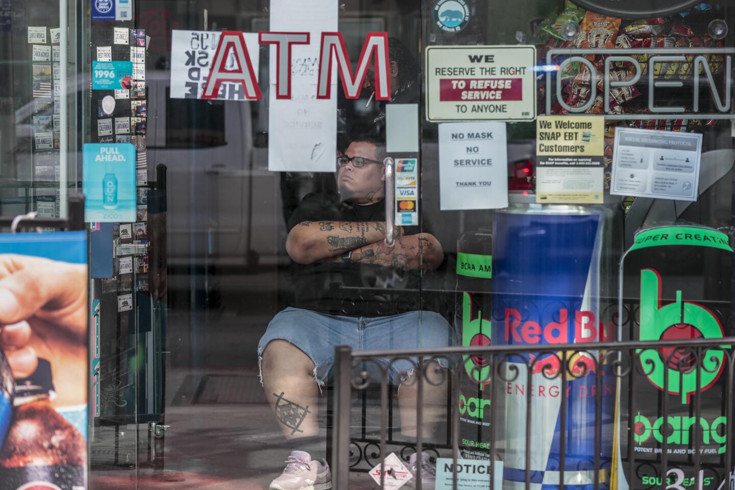 A man guards a convenience store in Santa Monica.