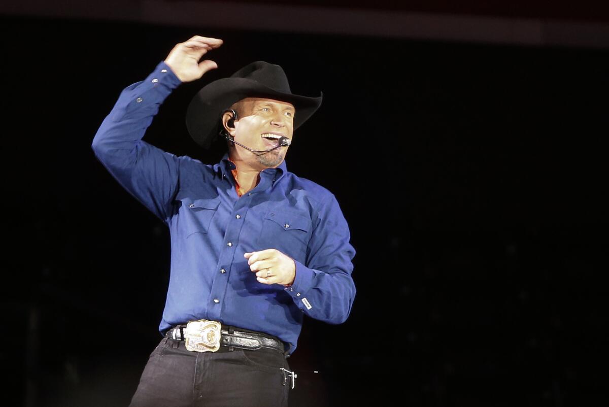 Garth Brooks performs in New York on July 8. On Wednesday, a week after launching its new paid streaming music service, Amazon announced a deal with Brooks.