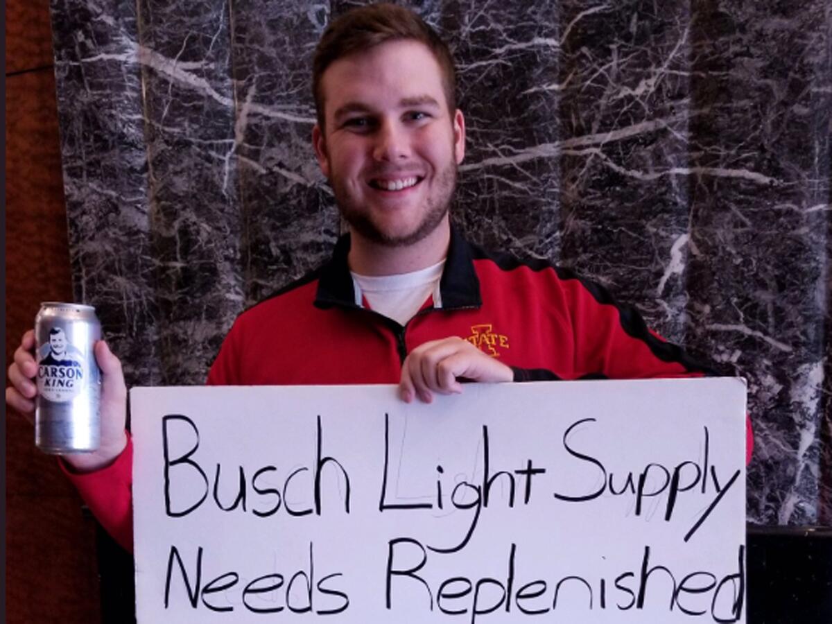 Carson King holds the sign that ended up raising more than $1 million for a children's hospital in Iowa.