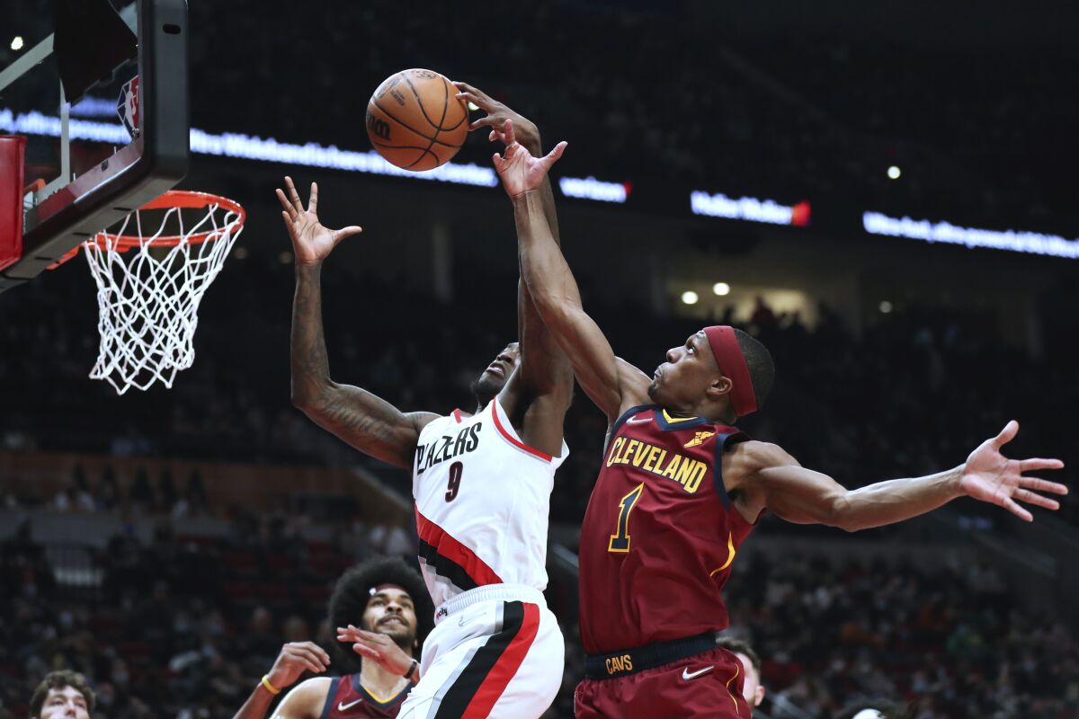 Cleveland Cavaliers guard Rajon Rondo attempts to block a shot by Portland Trail Blazers forward Nassir Little during the first half of an NBA basketball game in Portland, Ore., Friday, Jan. 7, 2022. (AP Photo/Amanda Loman)