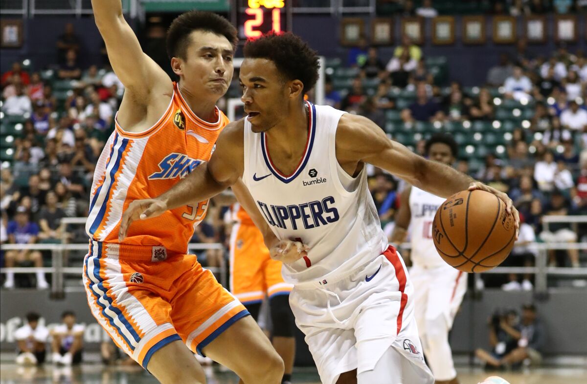 Clippers guard Jerome Robinson drives past Luo Hanchen of the Shanghai Sharks during an exhibition Sunday in Honolulu.
