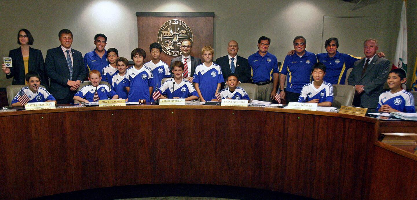 The AYSO Region 88 boys U12 soccer team, representing Glendale and La Crescenta, sit on the Glendale City Coucil dais with their coaches and the members of the City Council after receiving a Mayor's Comendation at the Glendale City Council meeting at Glendale City Hall on Tuesday, June 24, 2014. The team from Region 88 is the only team in the West to represent AYSO in the national tournament that will take place in July in Torrance.