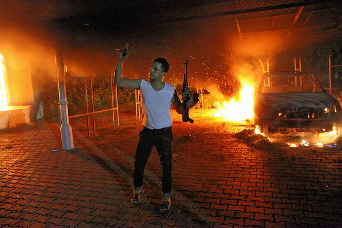 A man brandishes his weapon at the U.S. mission in Benghazi, Libya, the night it came under attack by Islamist militants.