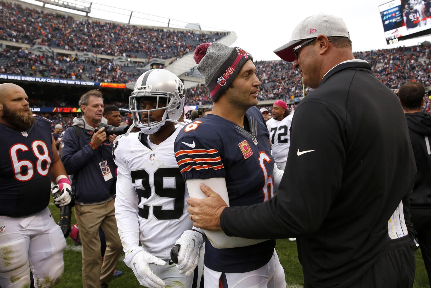 Jay Cutler chats with former Bears offensive coordinator Mike Tice and Oakland Raiders offensive line coach following a 22-10 Bears win.