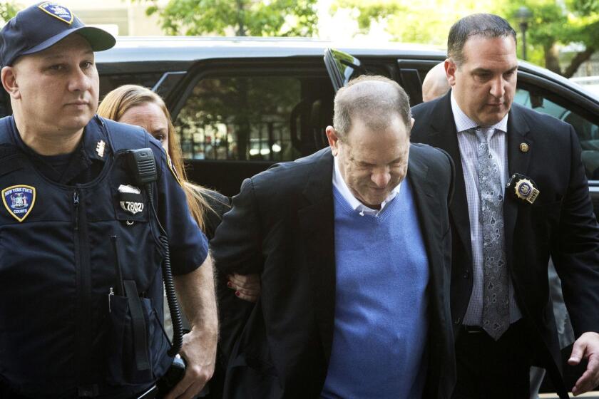 Harvey Weinstein is escorted into court, Friday, May 25, 2018, in New York. Weinstein surrendered Friday to face rape and other charges from encounters with two women. (AP Photo/Mark Lennihan)