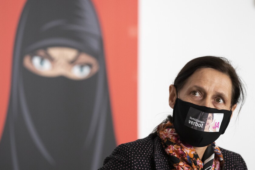 Monika Ruegsegger-Hurschler, National Councillor SVP, gives an interview at the meeting place of the supporters of the initiative to ban face coverings, in Bern on Sunday March 7, 2021. Swiss voters appeared on course Sunday to narrowly approve a proposal to ban face coverings, both the niqabs and burqas worn by a few Muslim women in the country and the ski masks and bandannas used by protesters. (Peter Klaunzer/Keystone via AP)