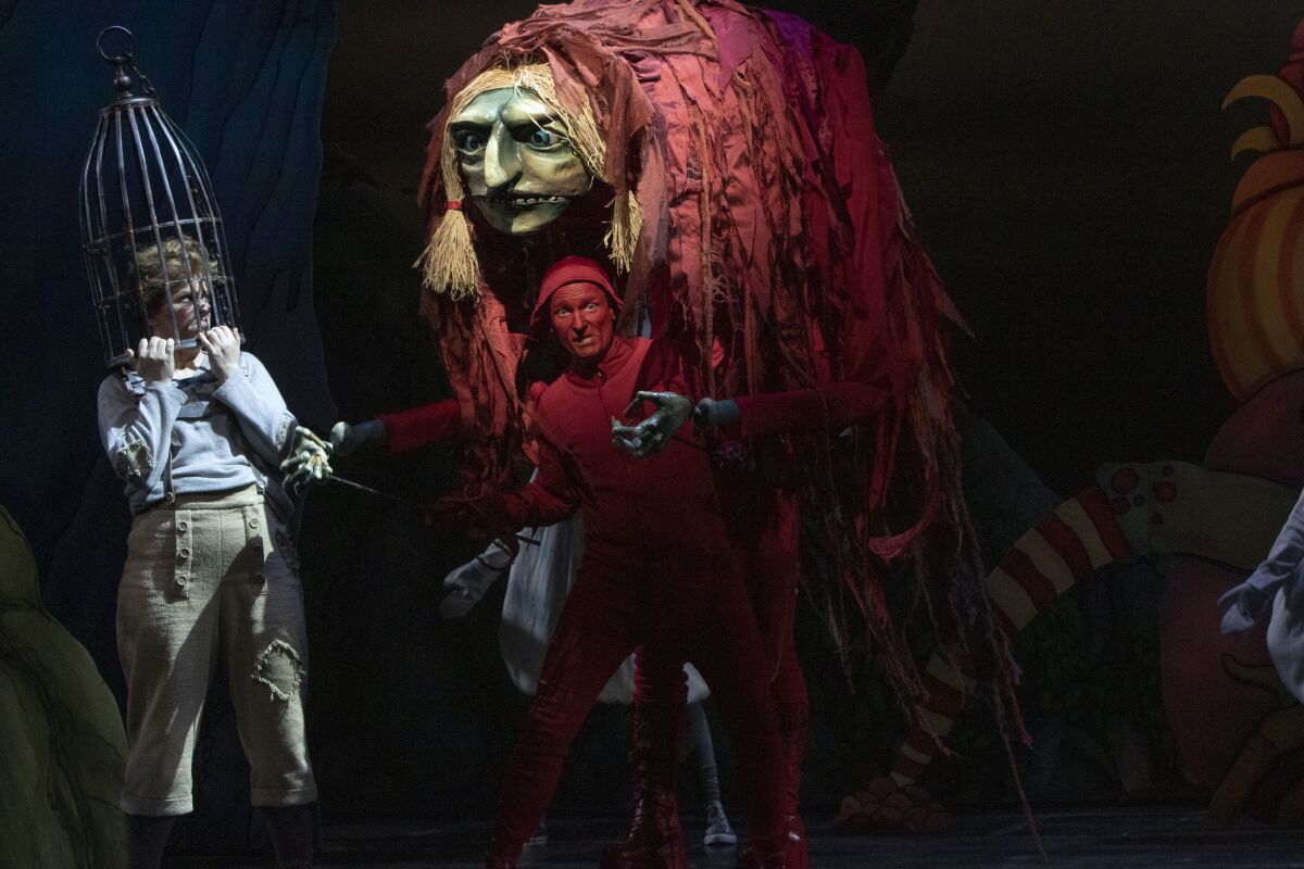 Mezzo-soprano Blythe Gaissert as Hansel, left, is trapped by the Witch, played by tenor Joel Sorensen, right, in San Diego Opera's production of "Hansel and Gretel" at the San Diego Civic Theatre.