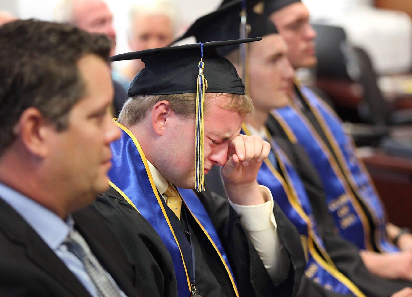 Graduate Christopher Swieca tears up at s the surprise commencement ceremony in his honor in the Chancellor's office at UCI on Tuesday. Swieca could not attend his commencement with his fellow water polo players due to an eye surgery.