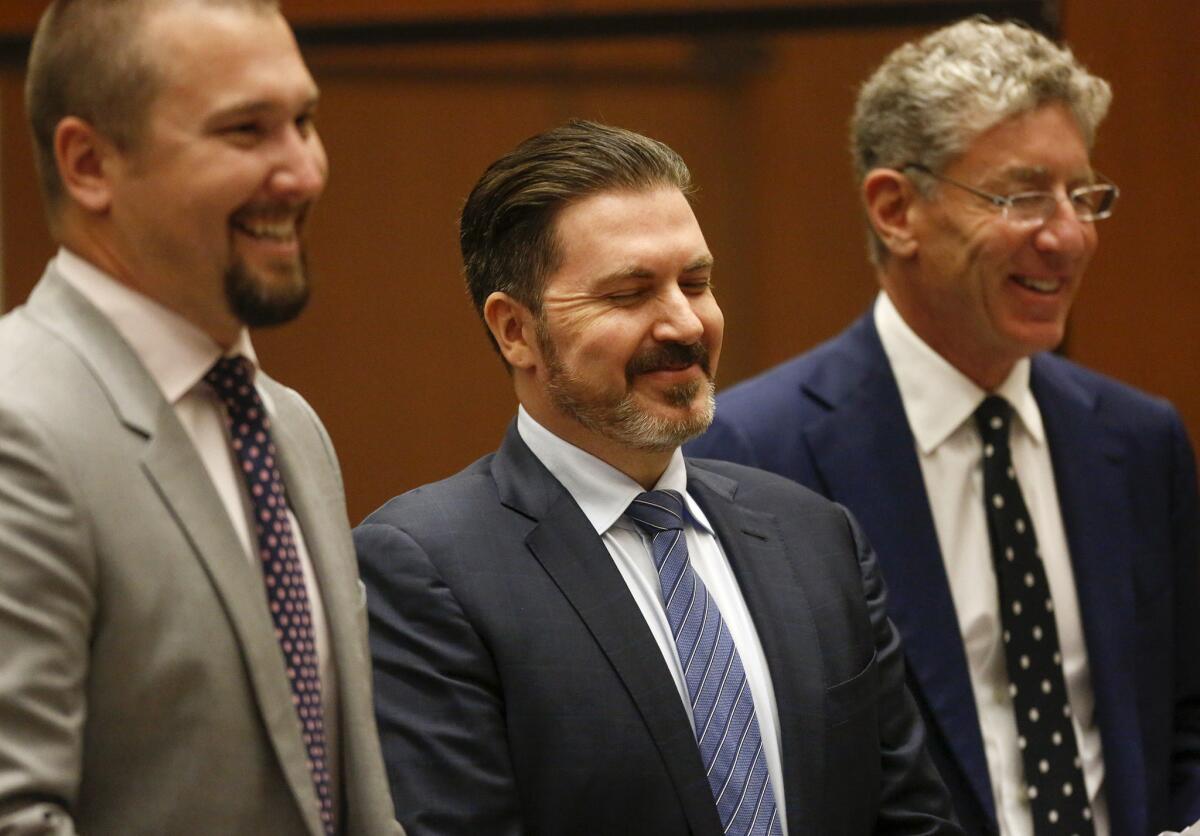 Defense attorneys and rave promoter Pasquale Rotella, center, share a light moment in court earlier this week when Rotella pleaded to a misdemeanor in the Coliseum corruption case. He was placed on three years' probation and ordered to pay $150,000 to the county.
