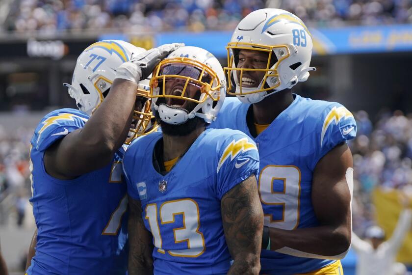 Los Angeles Chargers wide receiver Keenan Allen, center, celebrates with guard Zion Johnson.