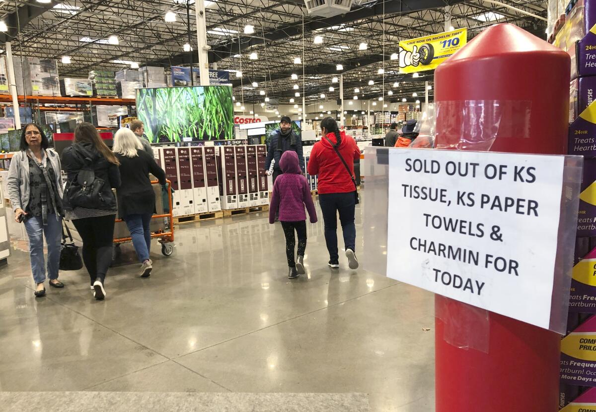 Shoppers visit a Costco Wholesale in Tigard, Ore., on Saturday.