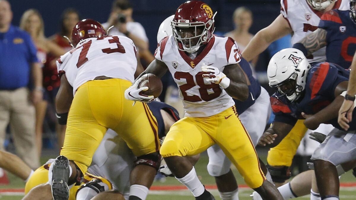 USC running back Aca'Cedric Ware finds a hole to run through in the first half against Arizona on Sept. 29 in Tucson, Ariz.