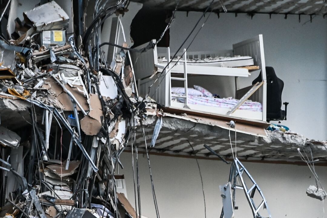 Rubble hangs from a partially collapsed building in Surfside north of Miami Beach.