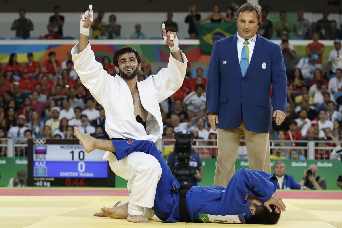 Russia's Beslan Mudranov celebrates after defeating Kazakhstan's Yeldos Smetov in the 60-kilogram judo gold medal match at the Olympics. Mudranov was Russia's first medalist in the Rio Games.