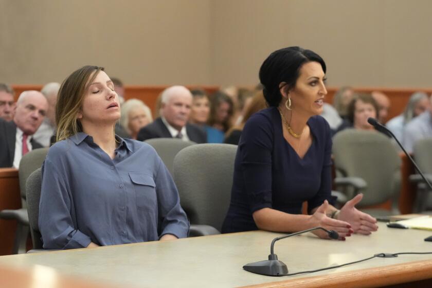 Kouri Richins, left, a Utah mother of three who authorities say fatally poisoned her husband, Eric Richins, then wrote a children's book about grieving, listens as her attorney Skye Lazaro speaks during a status hearing Friday, Sept. 1, 2023, in Park City, Utah. (AP Photo/Rick Bowmer, Pool)
