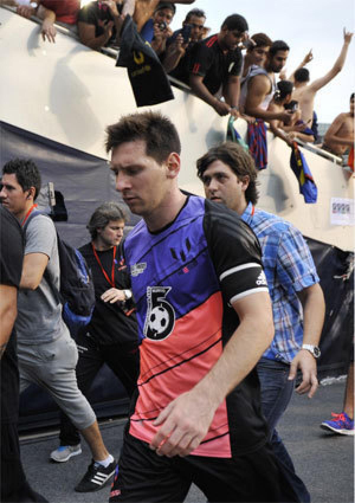 Lionel Messi walks off the field after coming out of his charity game Saturday in Chicago.