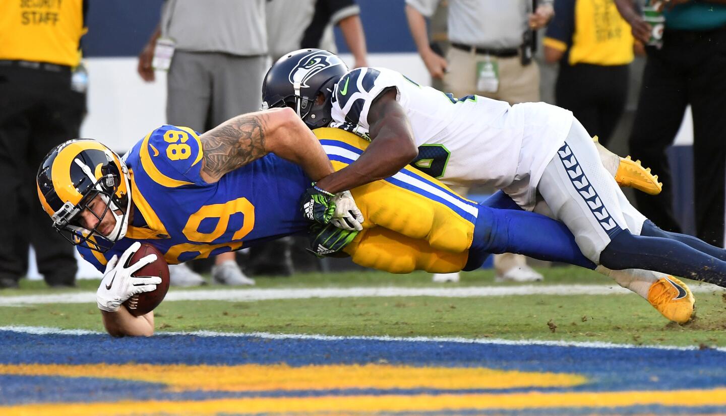 Rams tight end Tyler Higbee scores a touchdown against Seattle Seahawks cornerback Justin Coleman in the fourth quarter at the Coliseum on Sunday.